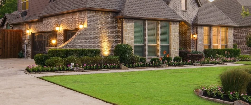 House in McKinney, TX, with outdoor lighting and manicured yard.