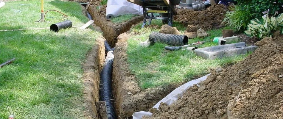 Installing drainage pipes for a yard in McKinney, TX.