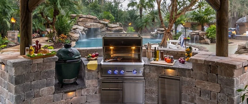 Outdoor kitchen beside pool in Plano, TX.