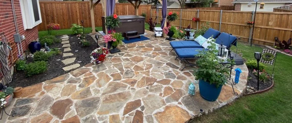 An outdoor living space with a flagstone patio and other elements.