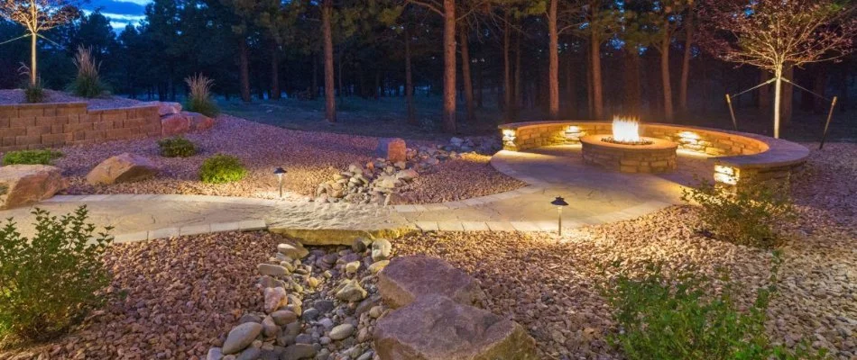 Residential backyard in Plano, TX, with gravel landscaping and a fire pit.