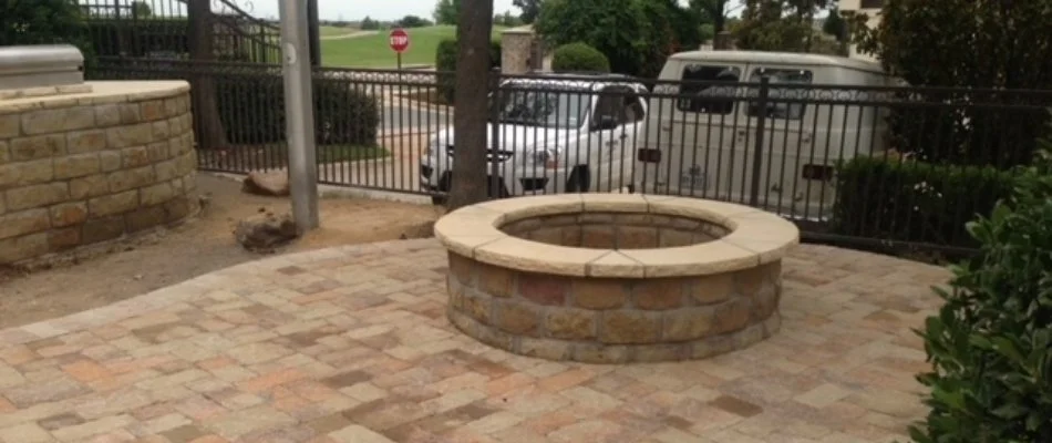 Round fire pit in McKinney, TX, installed on a patio.