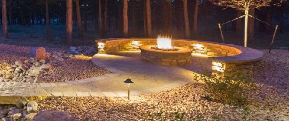 Round fire pit with seating wall in McKinney, TX.