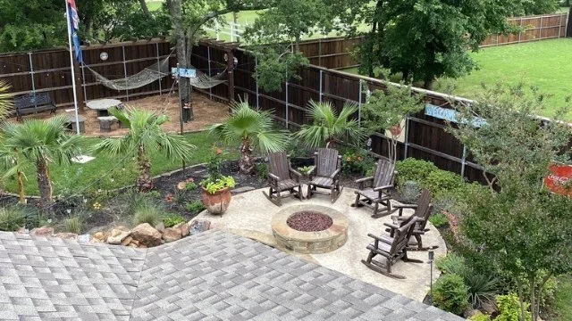 Aerial view of a backyard in McKinney, TX with fire pit and plantings.