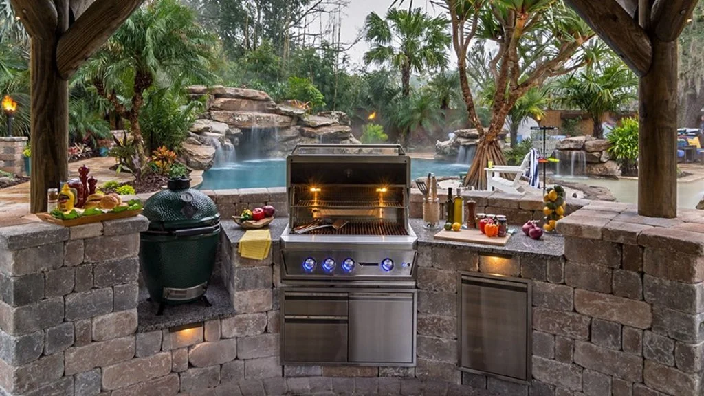 Outdoor kitchen with grill and pool in McKinney, TX backyard.